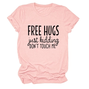 Detail of Free Hugs Just Kidding slogan printed on a pink cotton crewneck T-shirt