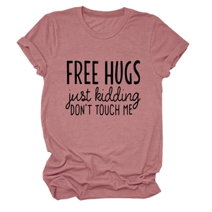 Close-up of soft dusty rose cotton t-shirt with 'FREE HUGS' slogan and crew neckline