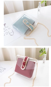 Detail view of transparent PVC crossbody bag with colorful inner pouches and chain strap