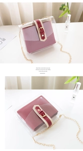 Detailed view of clear PVC tote with purple inner pouch and gold chain strap