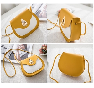 Detail of water drop gold hardware clasp on yellow and white contrast saddle bag