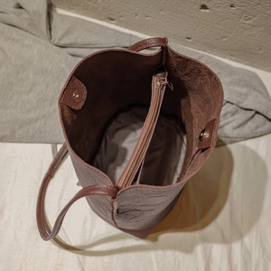 Deep brown bucket bag with spacious interior compartment and magnetic closure for women