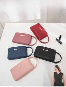 Flat lay of colorful wristlet wallets in five colors on a minimalist white surface
