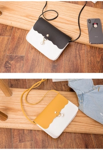 Detail of crossbody mini square bags with wave edge design and pearl pendant accent