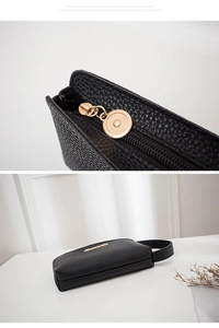 Macro view of litchi pattern leather texture and golden zipper detail on black clutch