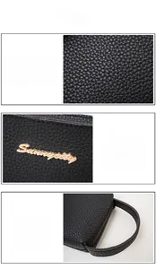 Detail of black lychee grain PU leather clutch with gold metal logo and side handle