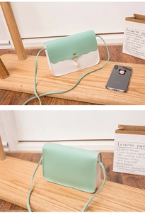 Detail of mint green and white crossbody bag with pearl charm and wavy flap design
