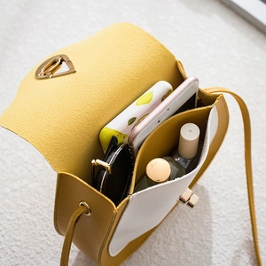 Contrast yellow and white saddle bag with double compartments and metal hardware