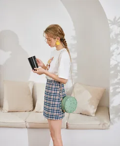 Detailed embroidery of floral patterns on the light green round PU leather crossbody bag