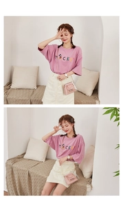 Detail of Mickey print T-shirt paired with a pink transparent chain mini square bag