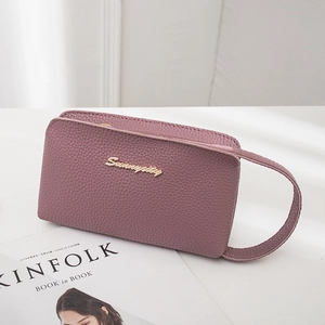 Purple lychee grain leather wristlet bag with gold logo on white background
