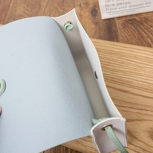 Minimalist light blue crossbody phone bag with magnetic clasp and silver hardware details