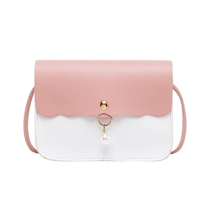 Pink and white crossbody flap bag with scallop edges and a pearl charm accent