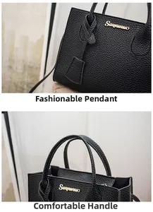Dettaglio del logo dorato e del ciondolo alla moda sulla borsa nera in pelle testurizzata