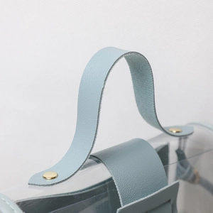 Light blue faux leather and transparent PVC shoulder bag with gold rivet accents