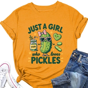 Flat lay of yellow t-shirt with pickle graphic, paired with jeans and sneakers