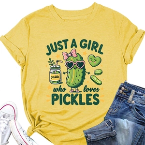 Close-up of yellow T-shirt with cartoon pickle print and 'JUST A GIRL who loves PICKLES' text