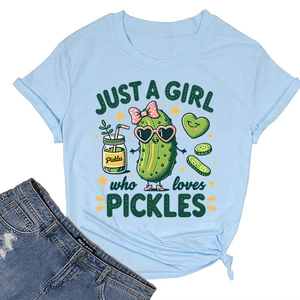 Flat lay of light blue cotton t-shirt featuring a retro cartoon pickle and denim shorts