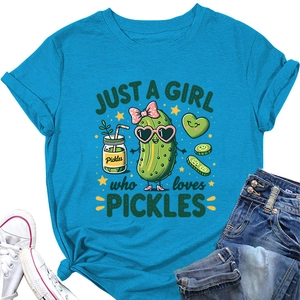 Flat lay of girl's blue pickles t-shirt with denim jeans and white canvas shoes