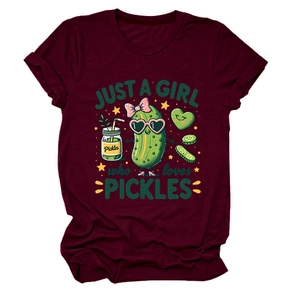 Close-up of funny cartoon pickle graphic and text on a burgundy cotton t-shirt