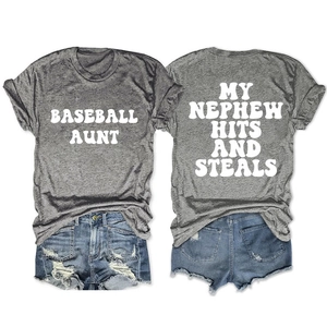 Detail of grey crewneck T-shirt with white text print paired with distressed denim shorts