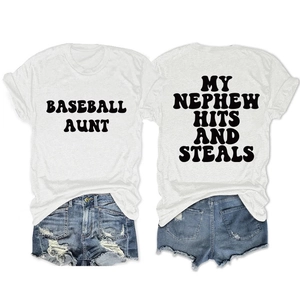 Flat lay detail of cotton t-shirts with Baseball Aunt and My Nephew Hits lettering