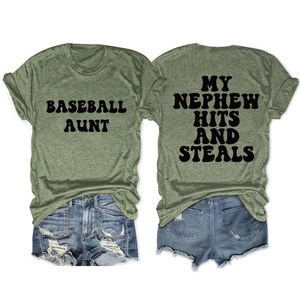 Detail of green T-shirt with BASEBALL AUNT text and distressed denim shorts on white backdrop