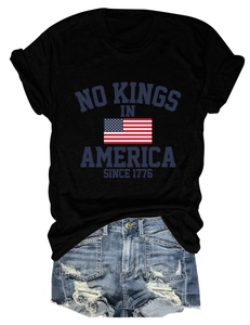 Mise à plat du t-shirt en coton No Kings in America avec un short en denim vintage