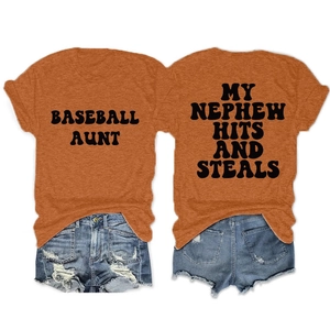 Flat lay of an orange cotton t-shirt with baseball slogans and denim shorts on white background