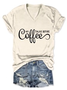 Flat lay of V-neck T-shirt with 'NO COFFEE TALKIE BEFORE' print and frayed denim shorts