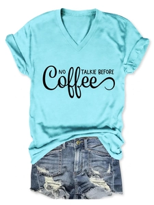 Flat lay of women's V-neck T-shirt with 'NO TALKIE BEFORE Coffee' slogan and denim shorts