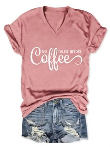 Flat lay of pink V-neck T-shirt with No Coffee Talkie Before text and denim shorts