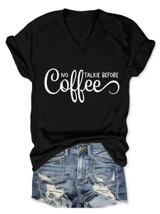 Detail of V-neck short sleeve T-shirt with 'NO TALKIE BEFORE' print and distressed shorts