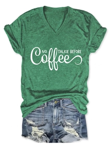 Detail of green heather V-neck T-shirt with No Talkie Before Coffee text and denim shorts