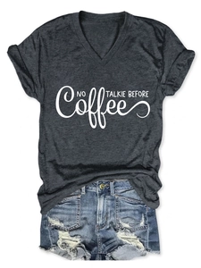 Detail of V-neck grey tee with No Talkie Before text and distressed denim shorts