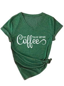 Detail of V-neck green T-shirt with 'NO TALKIE BEFORE Coffee' slogan and front knot design