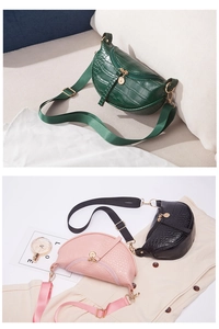 Detail of crocodile pattern crossbody bags in green, pink, and black with wide straps