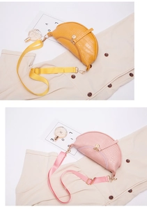 Vertical detail view of yellow and pink crocodile texture crossbody moon bags with straps