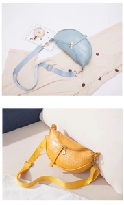 Detail of crocodile pattern half-moon chest bags in light blue and yellow with double zippers