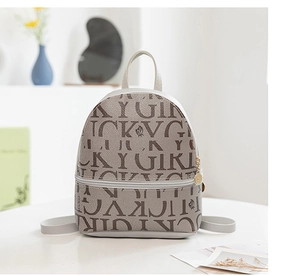 Close-up of Lucky Girl printed mini backpack with golden circular zipper and top handle
