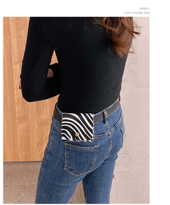 Detail of zebra print mini waist bag with gold buckle on model's back view