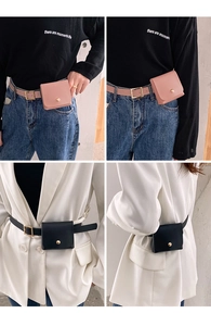 Detail of minimalist leather belt bag with round gold buckle and grainy leather texture