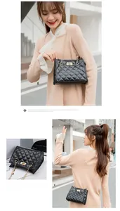 Close-up of black quilted bucket bag with gold chain strap and metal swivel lock