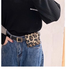 Detail of leopard print mini waist bag with golden buckle on black leather belt