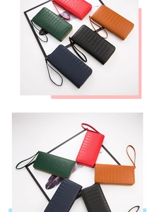 Detail showing five colors of crocodile pattern long wallets with wrist straps and zippers
