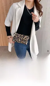Detail shot of leopard print waist bag with fine gold chain and classic flap design