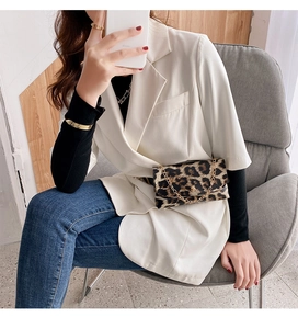 Fashionable leopard print waist bag with gold chain strap worn on a white suit