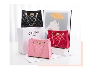 Detailed view of quilted bucket bags in black, red, and pink with gold chain handles