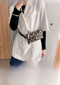 Close-up of leopard print waist bag with gold chain and round metallic buckle detail