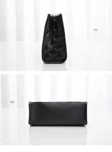 Detail view of the black quilted shoulder bag side profile and rectangular base structure